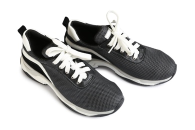 Pair of stylish modern training shoes on white background