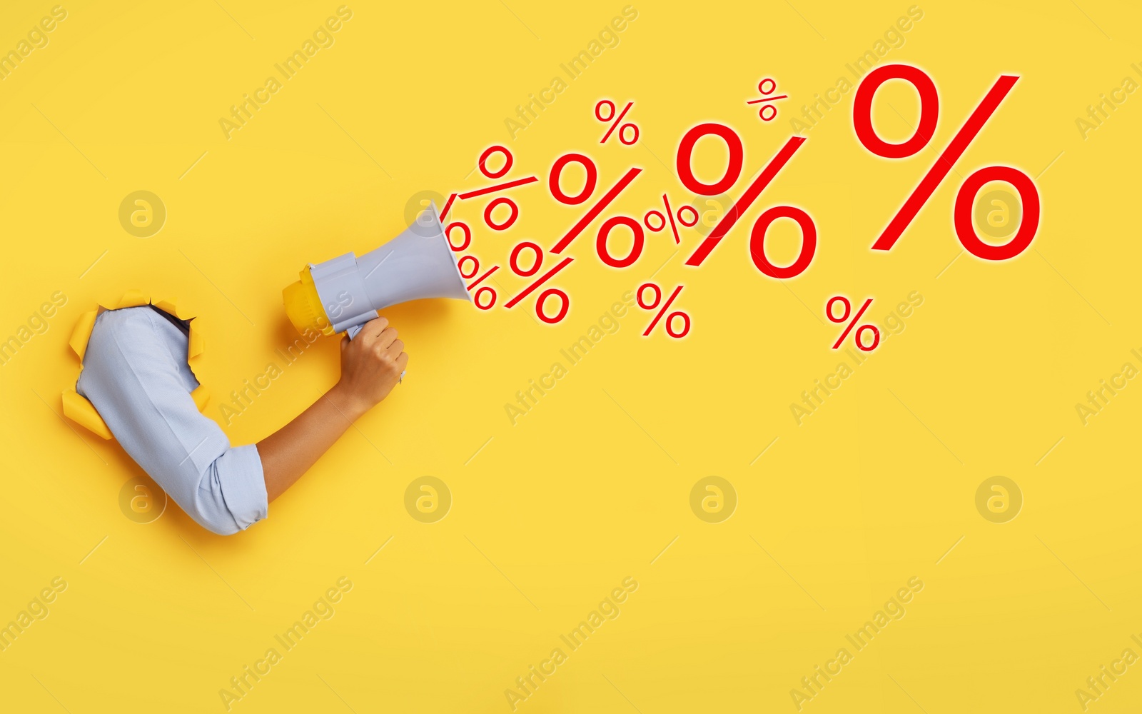 Image of Discount offer. Woman holding megaphone through hole in yellow paper, closeup. Percent signs coming out of device