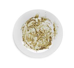Photo of Dirty plate with smeared sauce and pasta on white background, top view