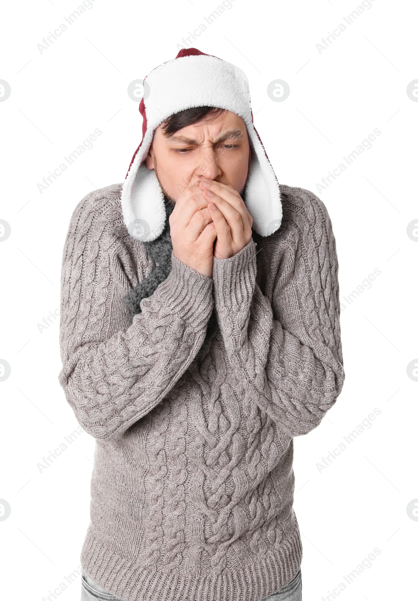 Photo of Man in warm clothes suffering from cold on white background