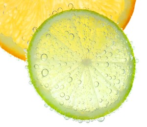 Slices of citrus fruits in sparkling water on white background, closeup