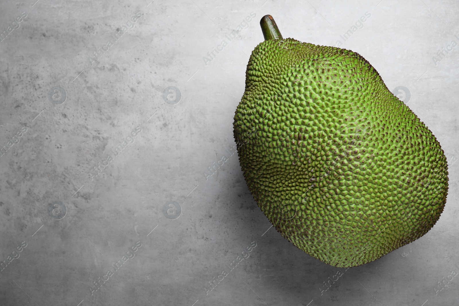 Photo of Delicious exotic jackfruit on light grey table, top view. Space for text