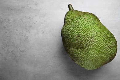 Photo of Delicious exotic jackfruit on light grey table, top view. Space for text