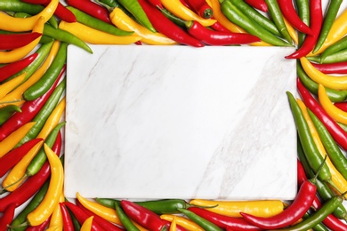 Photo of Flat lay composition with chili peppers and marble board