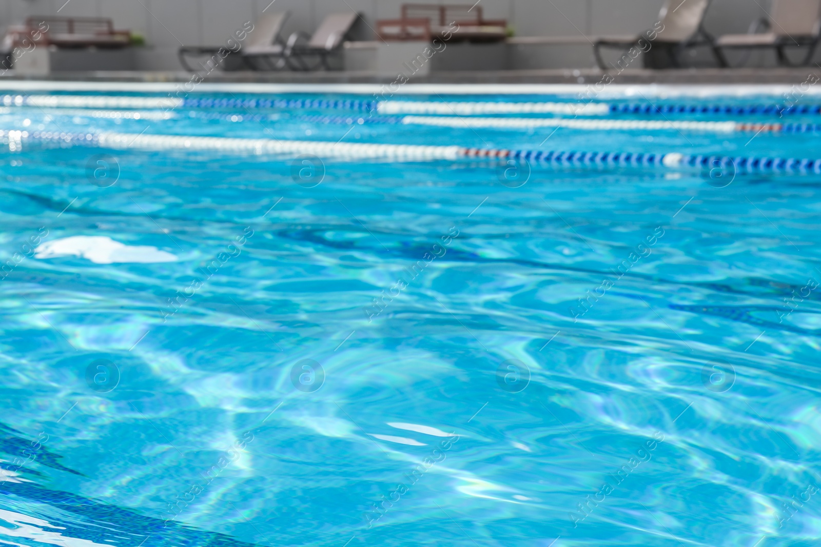 Photo of Blurred view of outdoor swimming pool with clear rippled water