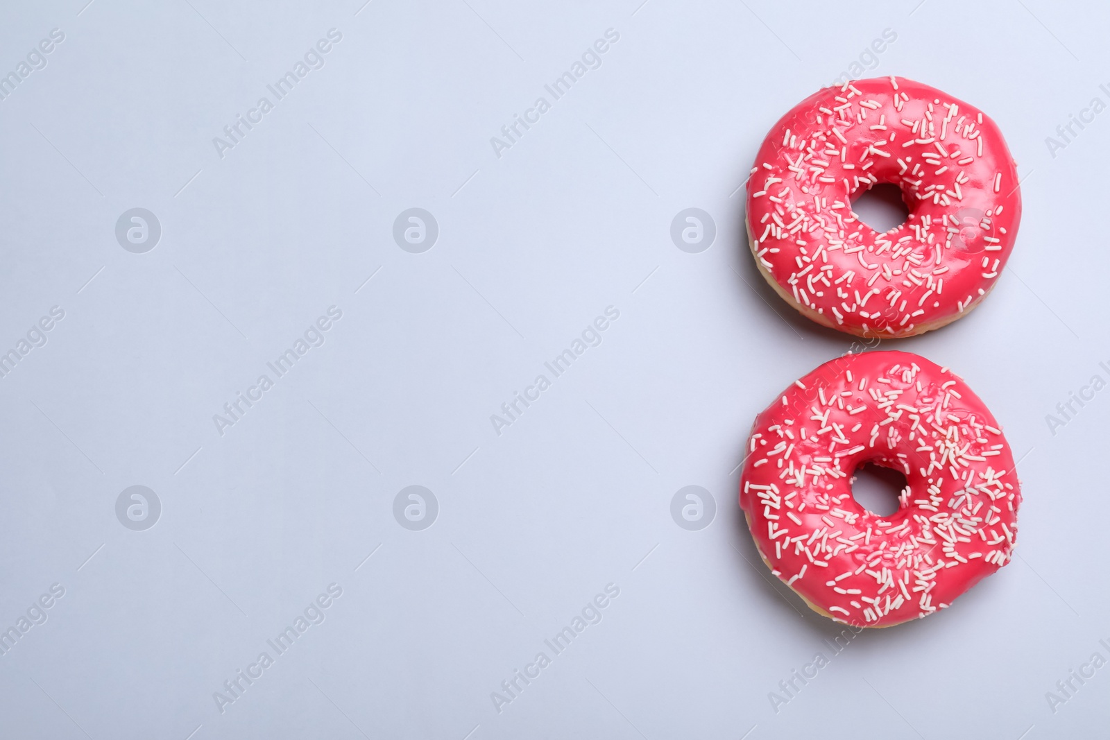 Photo of 8 March greeting card design with donuts and space for text on light grey background, flat lay. International Women's day