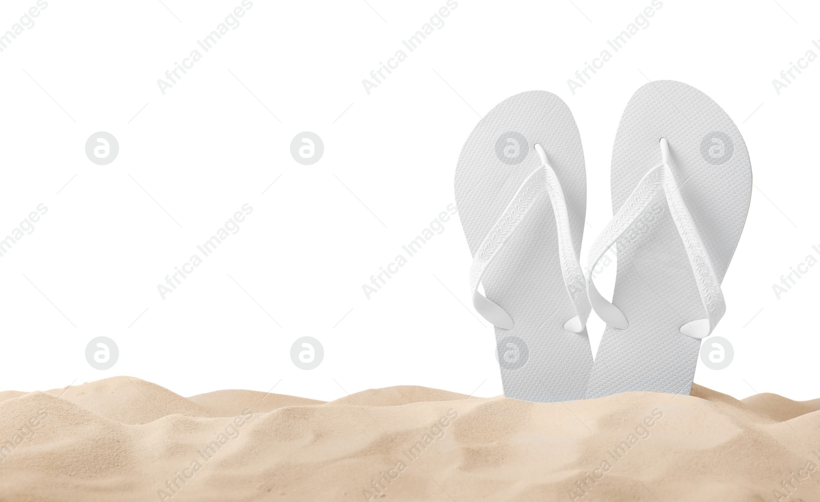 Photo of Bright flip flops in sand on white background