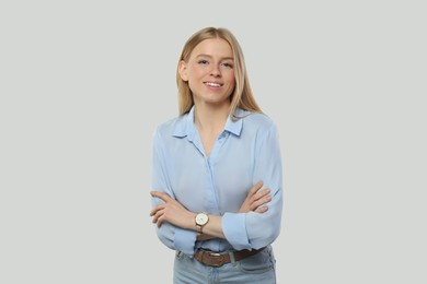 Portrait of beautiful young woman in stylish blouse on white background