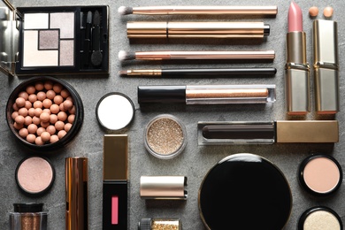 Photo of Set of luxury makeup products on grey background, flat lay