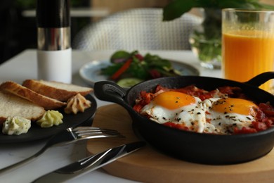 Tasty Shakshouka served on white table. Traditional Arabic dish