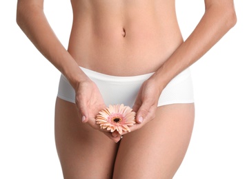 Photo of Young woman with gerbera flower on white background. Gynecology concept