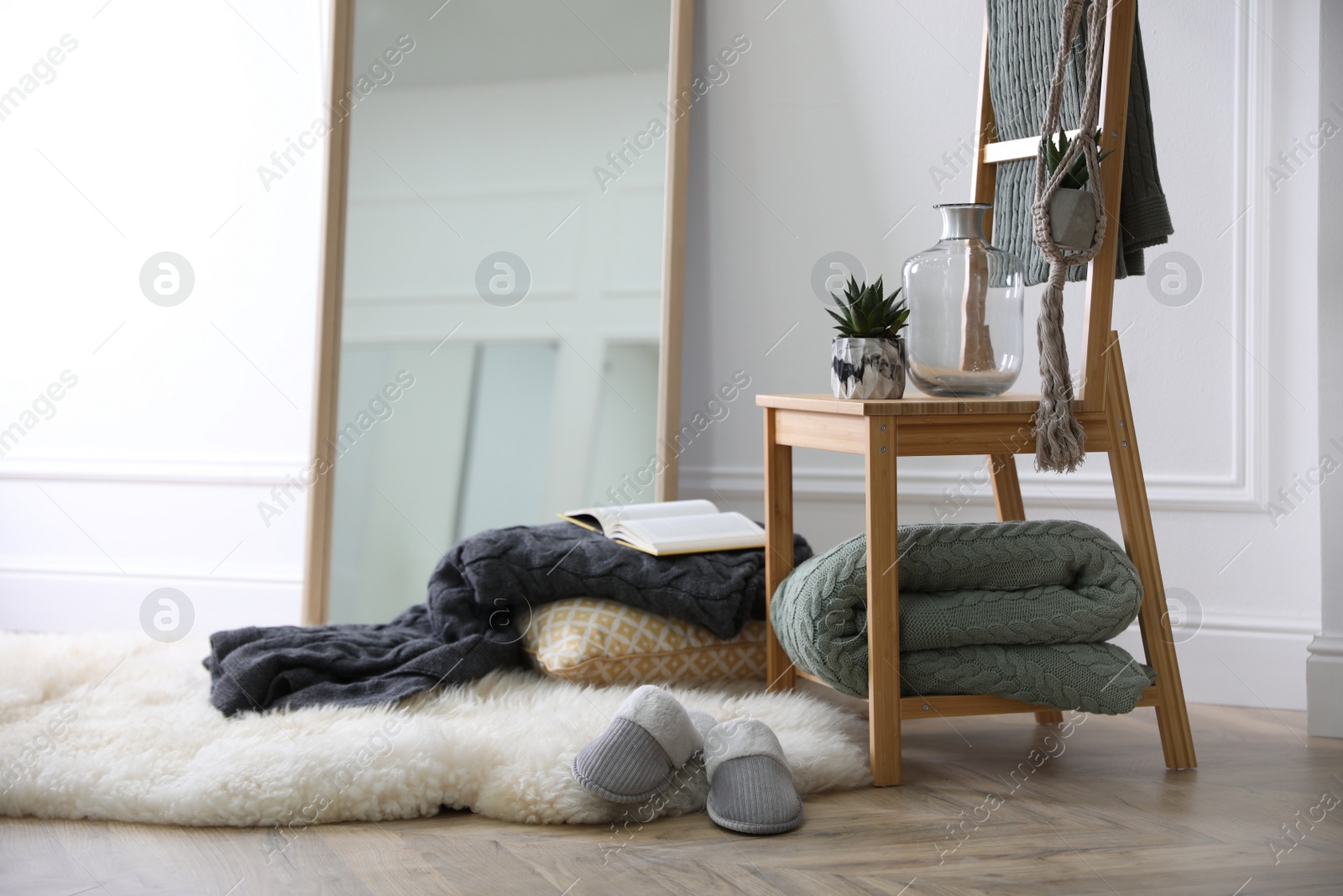 Photo of Comfortable place for rest with soft blankets and large mirror