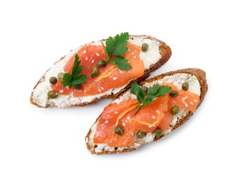 Photo of Tasty canapes with salmon, capers and cream cheese isolated on white, top view