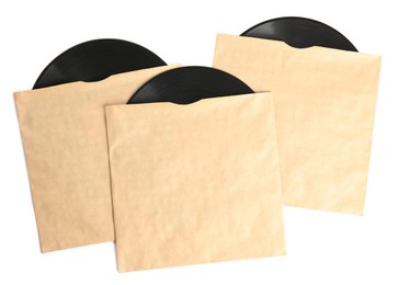 Photo of Vintage vinyl records in paper covers on white background, top view
