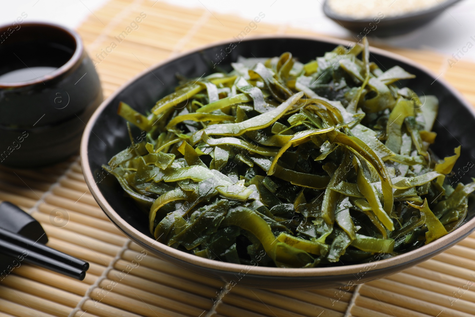 Photo of Fresh laminaria (kelp) seaweed served on table, closeup