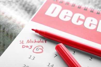 Photo of Saint Nicholas Day. Calendar with marked date December 06 and marker, closeup