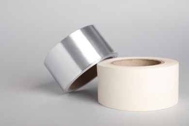 Photo of Two rolls of adhesive tape on light grey background