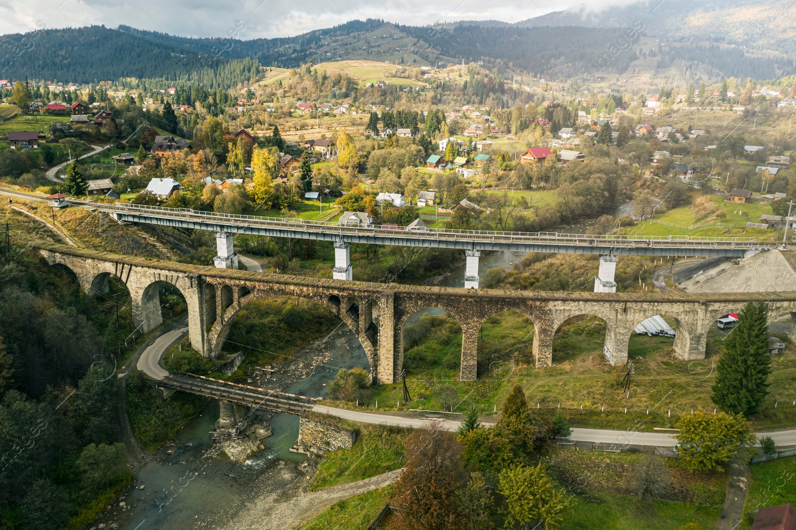 Image of Aerial view of bridges and village on autumn day