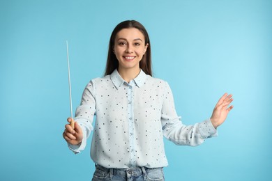 Photo of Music teacher with baton on turquoise background