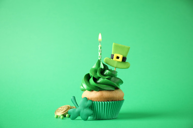 Decorated cupcake on green background. St. Patrick's Day celebration