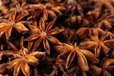 Photo of Aromatic anise stars as background, closeup view
