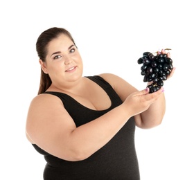 Photo of Overweight woman with grapes on white background