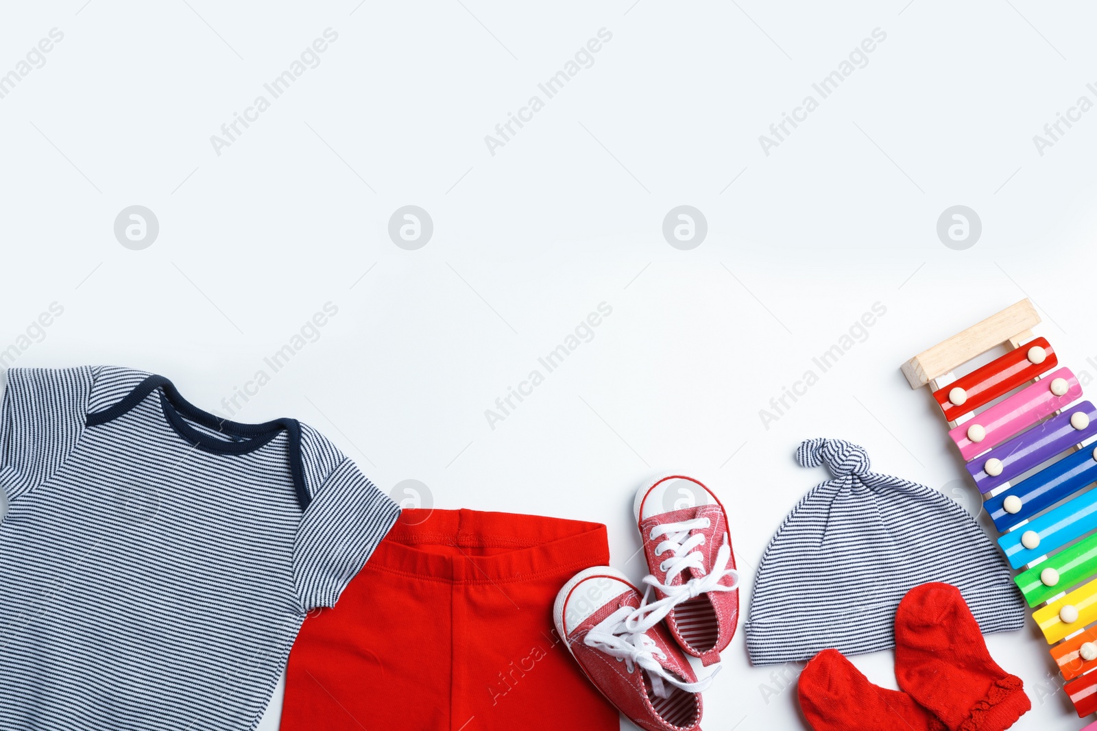 Photo of Composition with cute clothes and space for text on white background, flat lay. Baby accessories