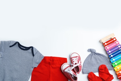 Photo of Composition with cute clothes and space for text on white background, flat lay. Baby accessories