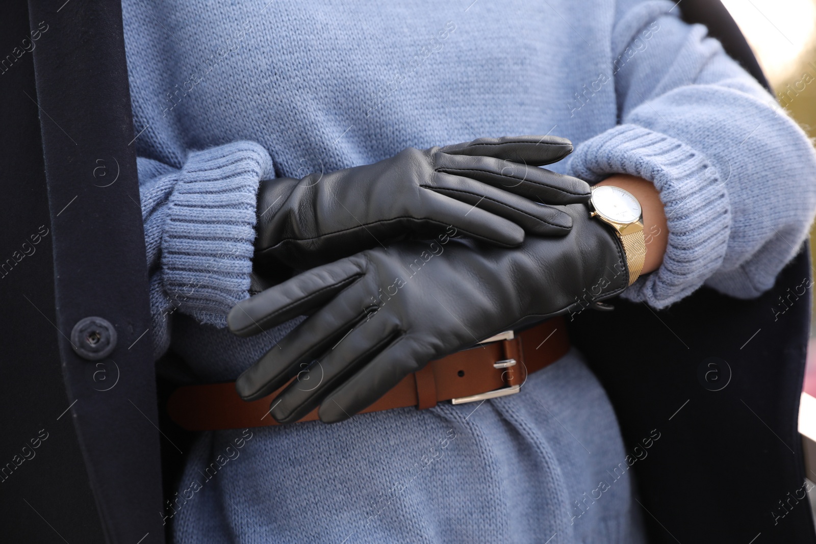 Photo of Young woman in stylish black leather gloves outdoors, closeup