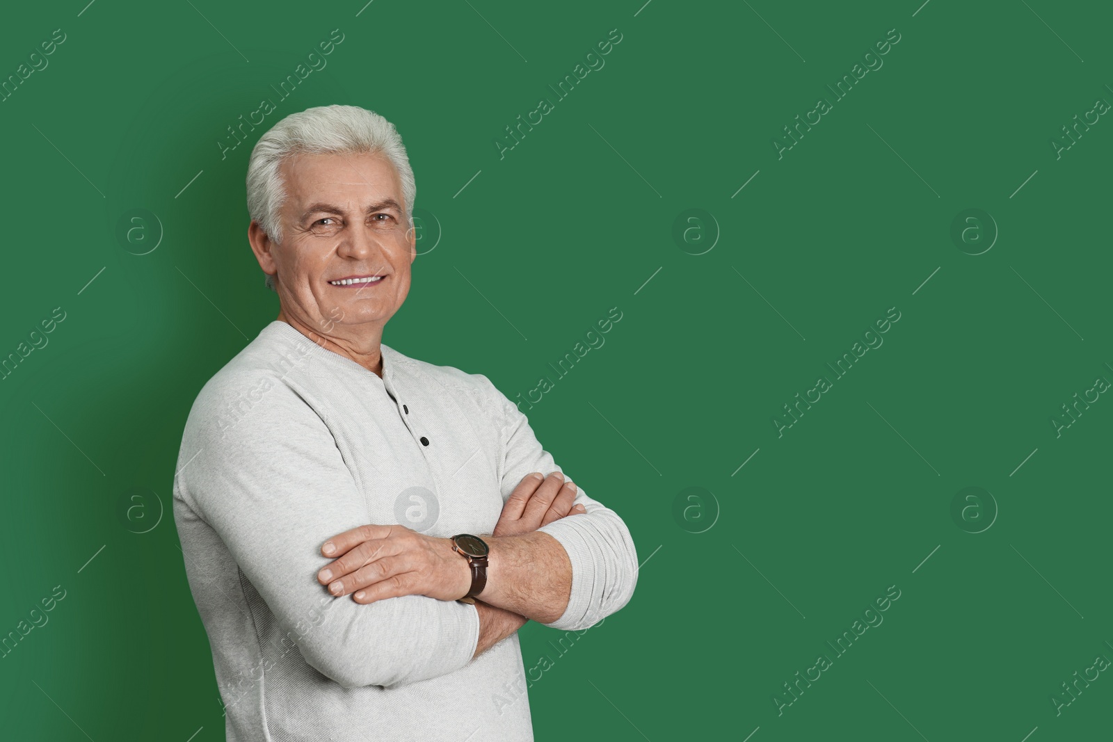 Photo of Portrait of handsome mature man on color background. Space for text