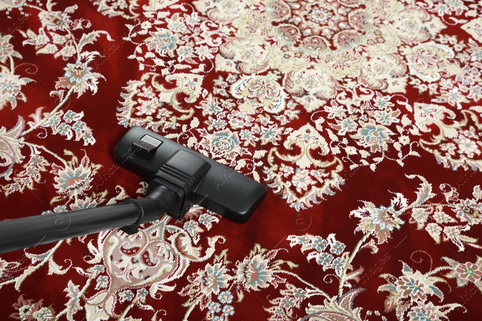 Photo of Removing dirt from carpet with modern vacuum cleaner, above view. Space for text