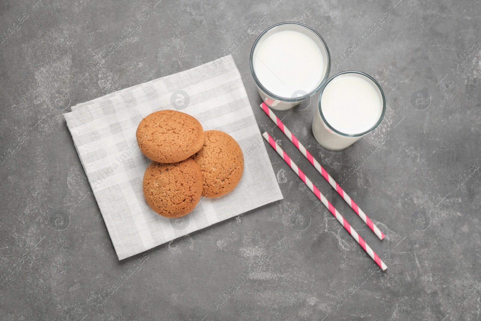 Photo of Glasses of milk and oatmeal cookies on table. Fresh dairy product