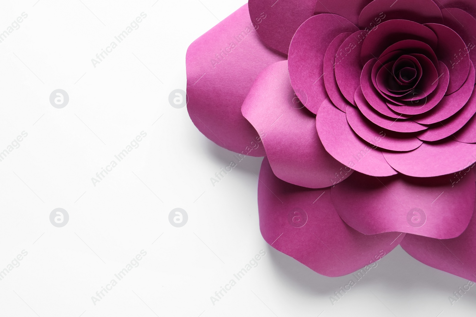 Photo of Beautiful pink flower made of paper on white background, top view