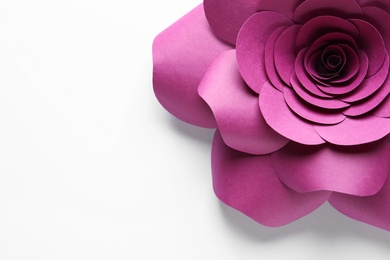 Beautiful pink flower made of paper on white background, top view