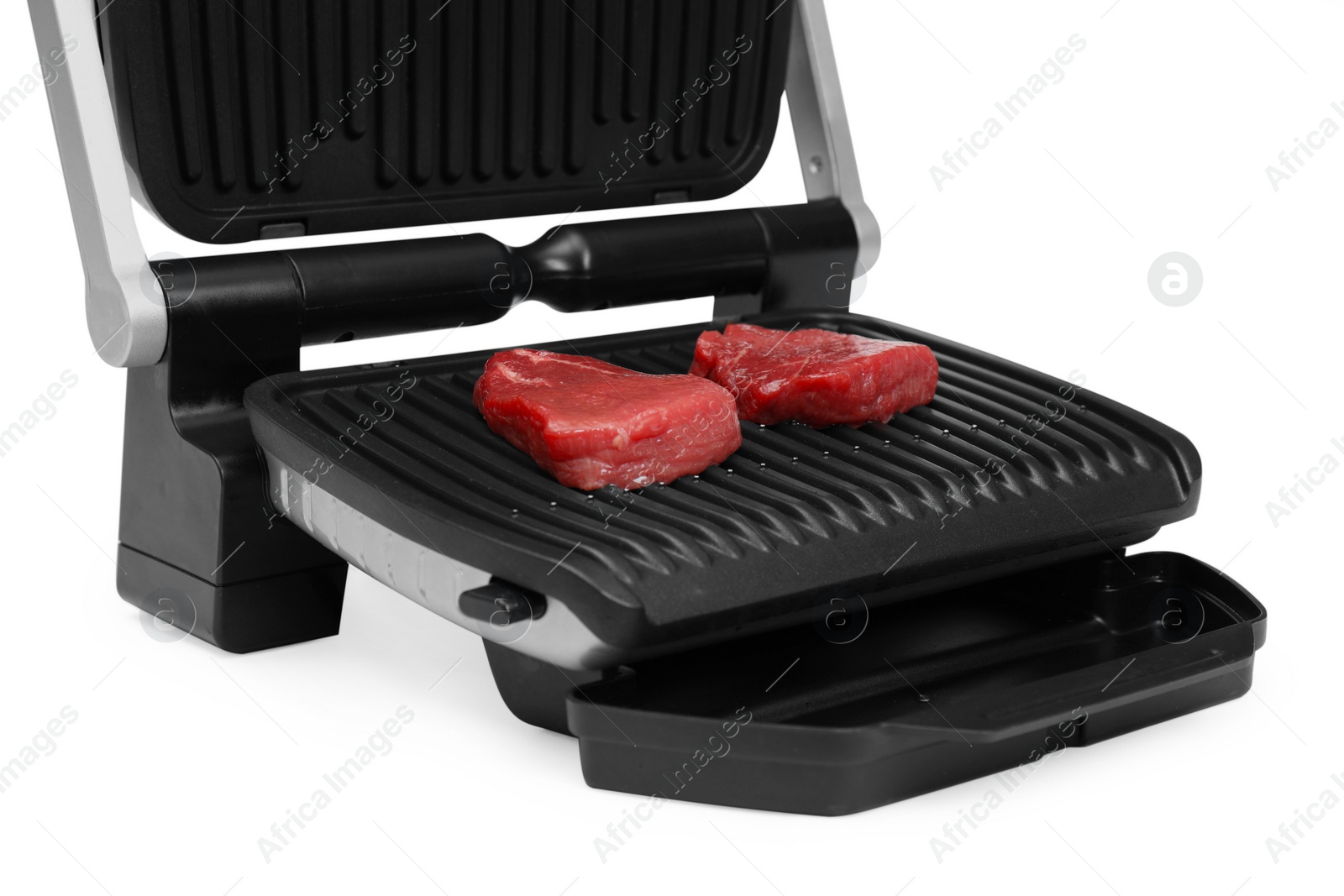 Photo of Electric grill with raw meat steaks isolated on white