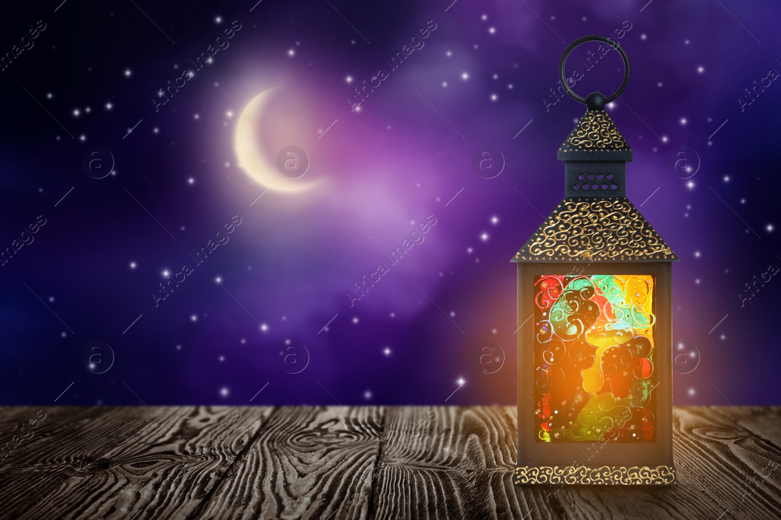 Image of Beautiful decorative Arabic lantern on wooden table at night, space for text. Fanous as Ramadan symbol