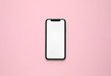 Photo of MYKOLAIV, UKRAINE - JULY 07, 2020: iPhone 11 on pink background, top view. Mockup for design
