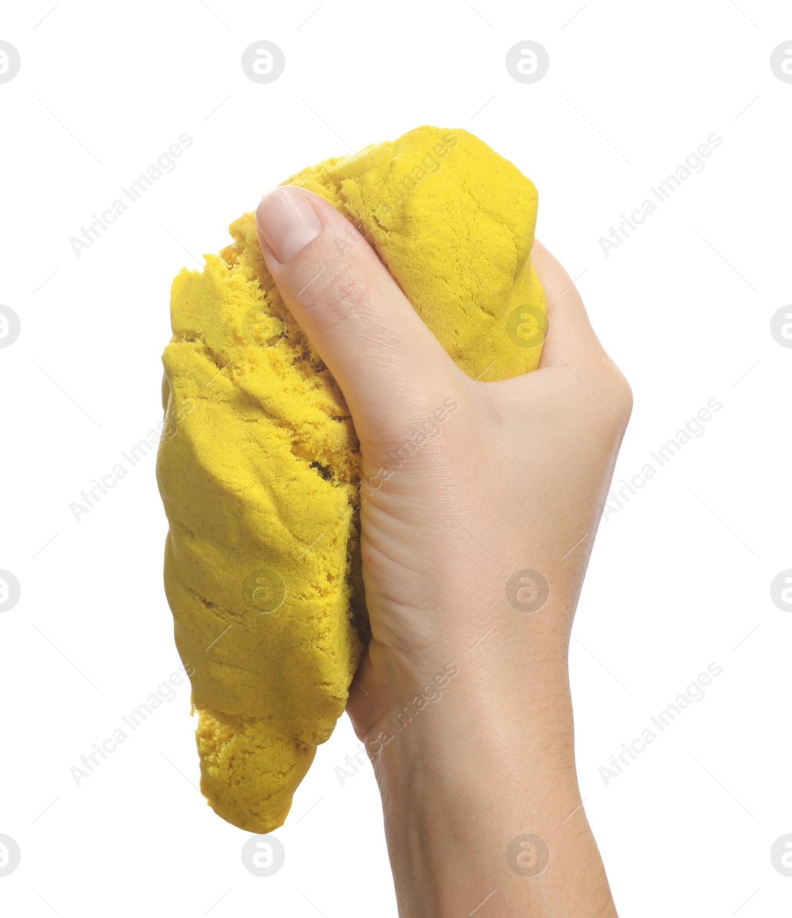 Photo of Woman playing with yellow kinetic sand on white background, closeup