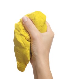 Woman playing with yellow kinetic sand on white background, closeup