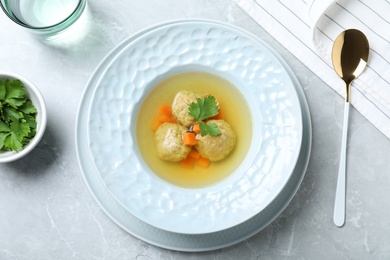 Flat lay composition with Jewish matzoh balls soup on light table