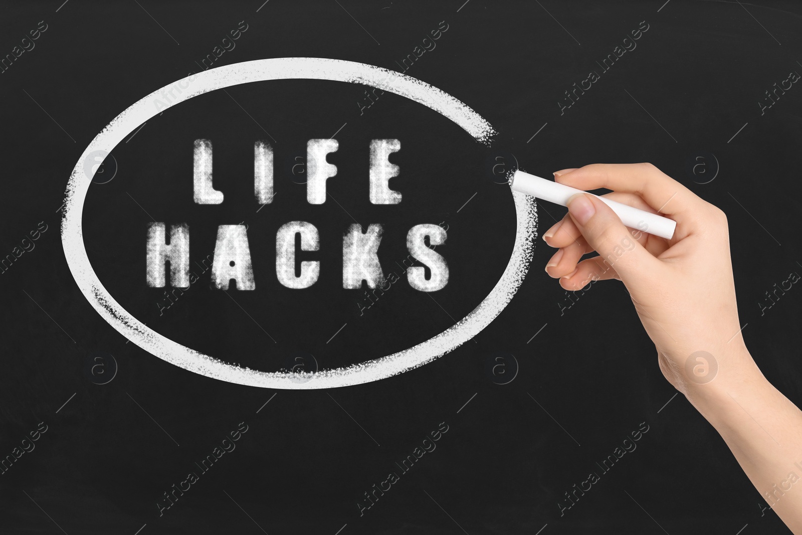 Image of Woman circling words Life Hacks with chalk on blackboard, closeup