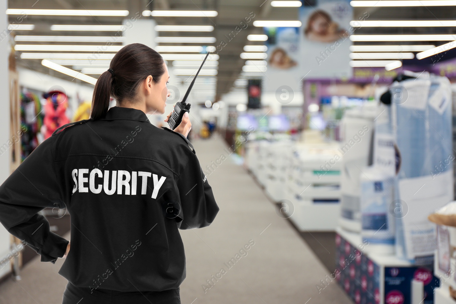 Image of Security guard using portable radio transmitter in shopping mall, space for text