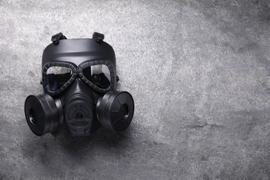 Photo of One gas mask on grey textured background, top view. Space for text