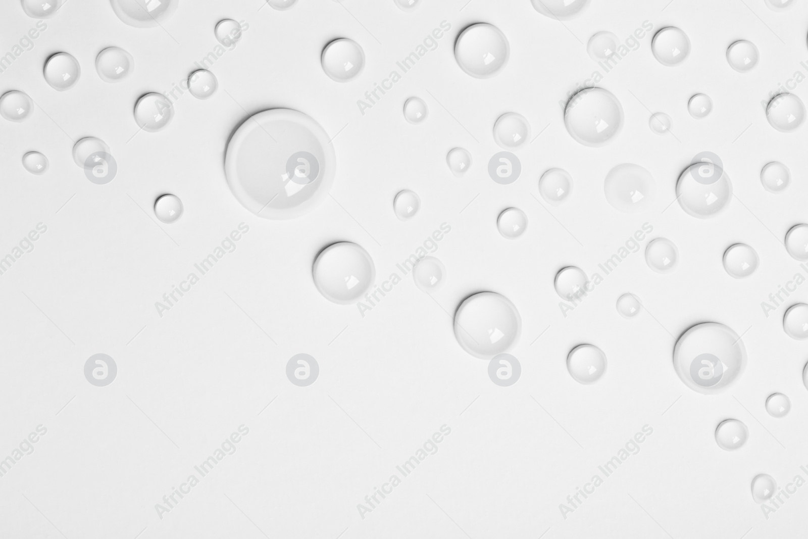 Photo of Water drops on white background, top view. Space for text