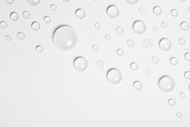 Water drops on white background, top view. Space for text