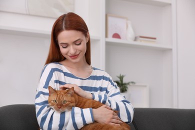 Photo of Woman with her cute cat at home, space for text