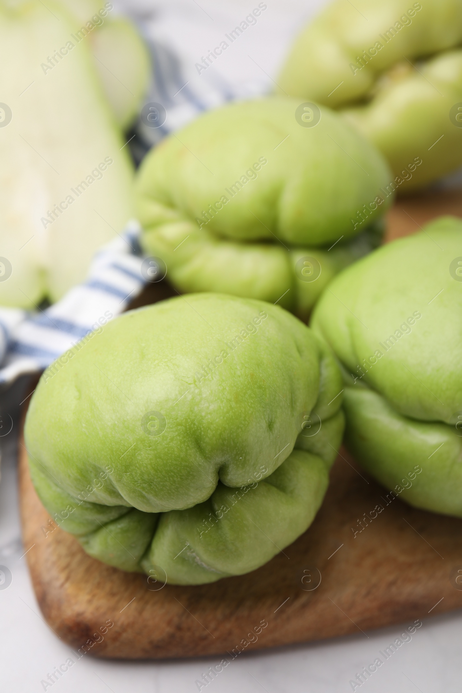 Photo of Fresh green chayote on light table, closeup