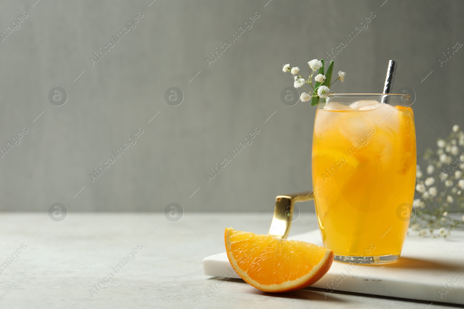 Photo of Delicious orange soda water on light table. Space for text