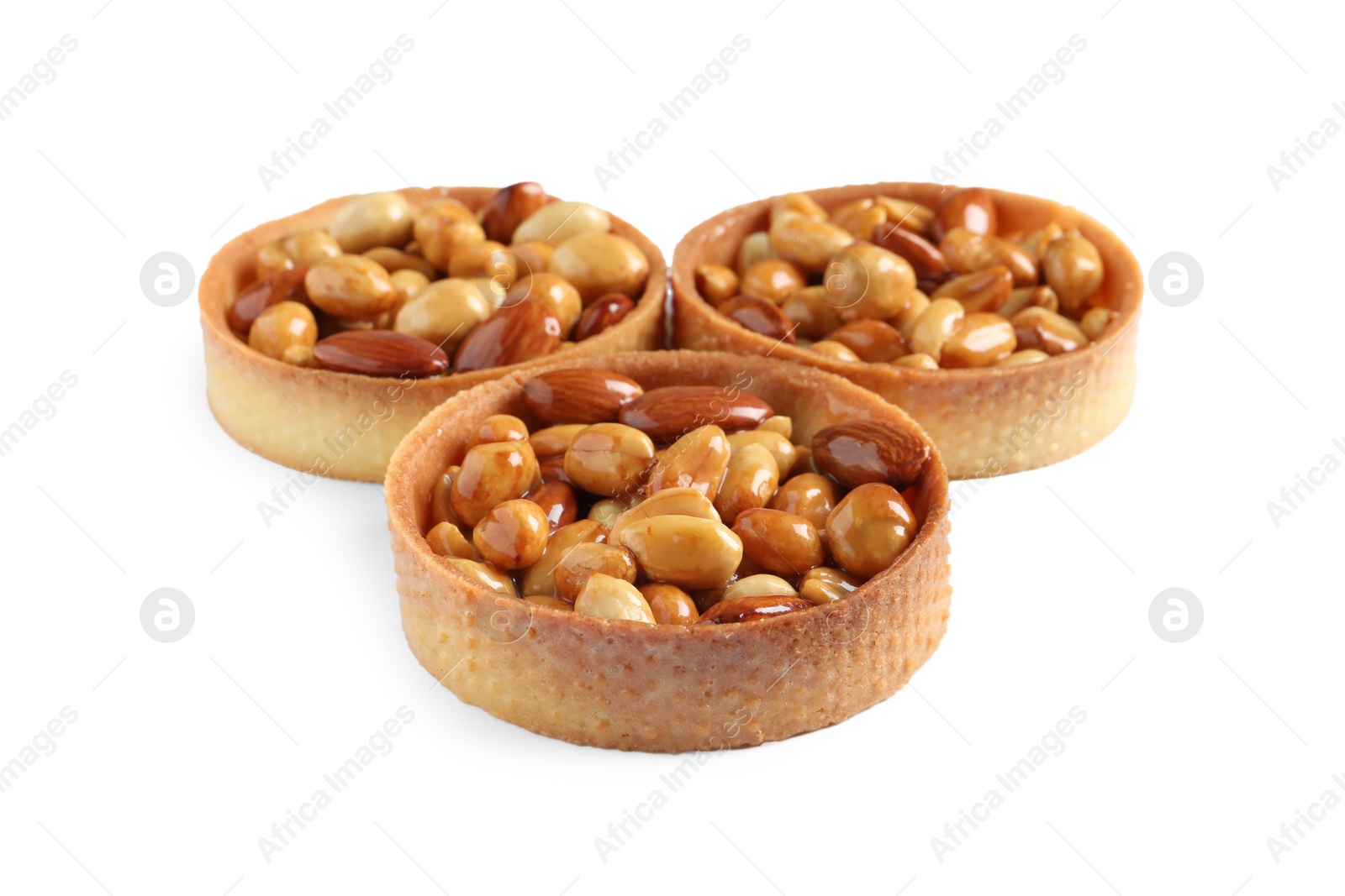 Photo of Tartlets with caramelized nuts isolated on white. Tasty dessert