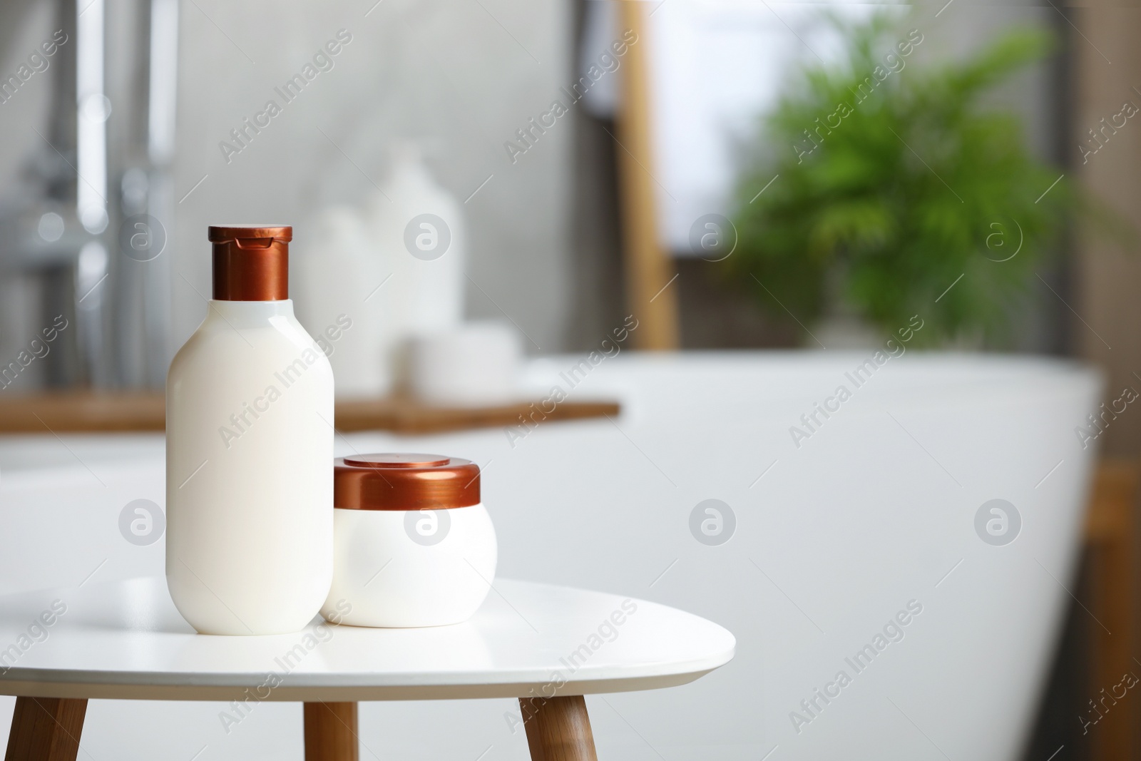 Photo of Shampoo and hair mask on white table in bathroom, space for text